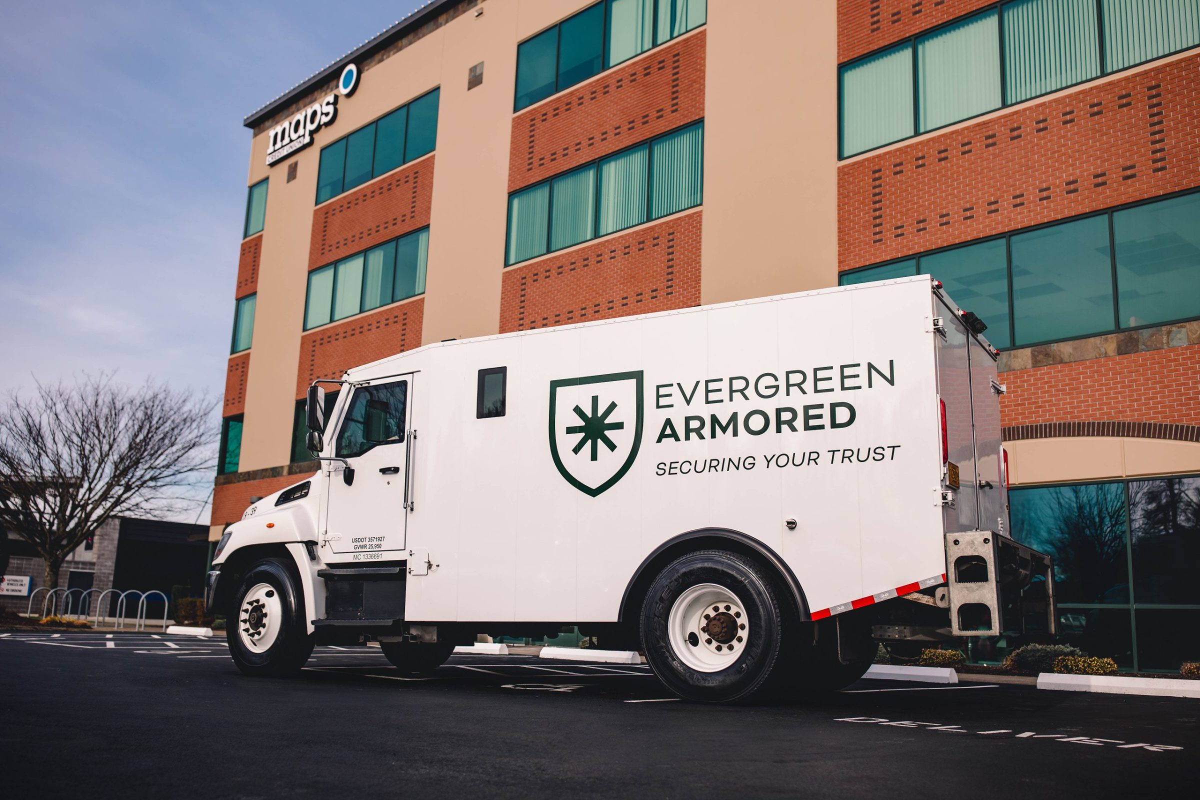 Evergreen Armored truck in front of building