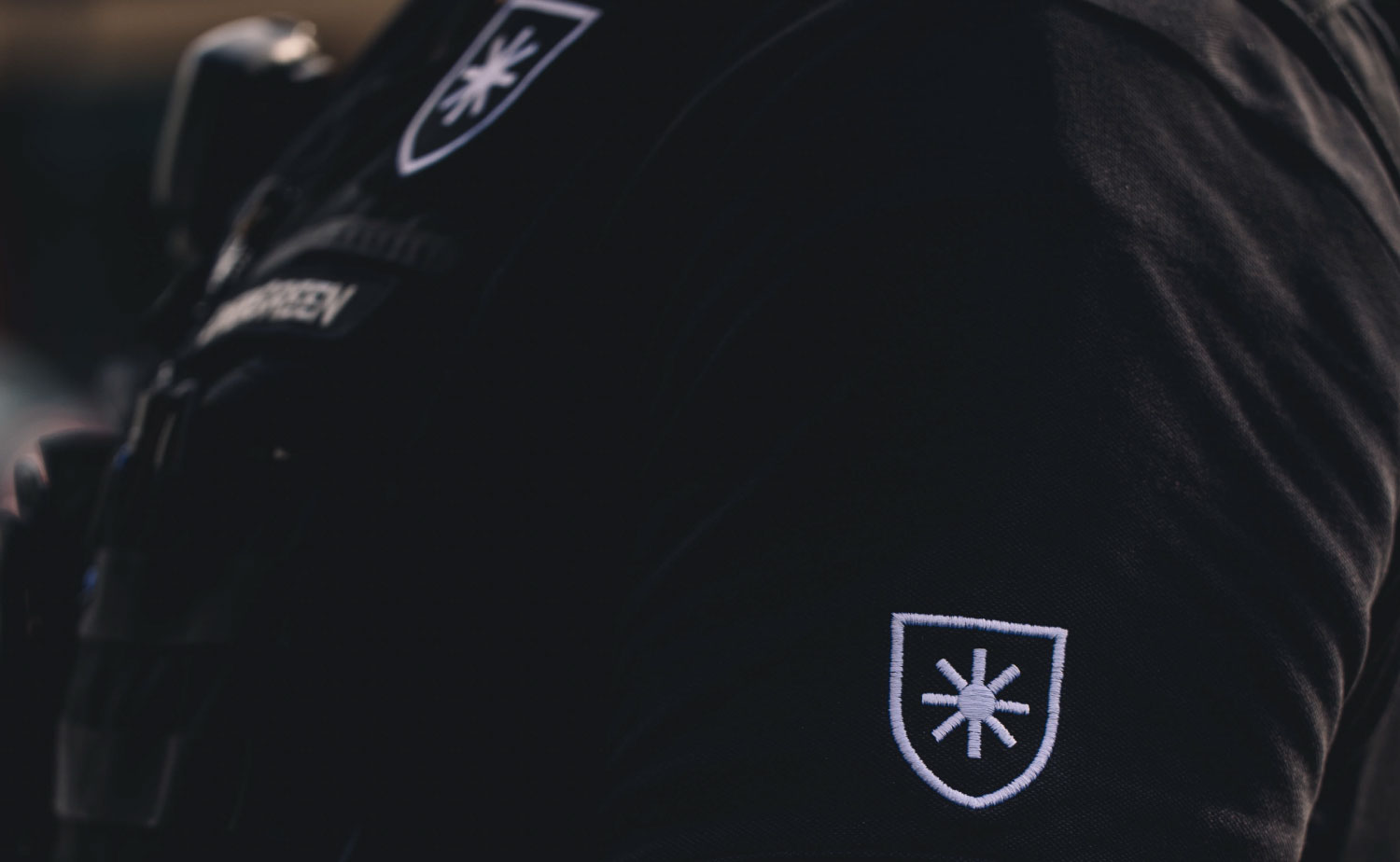 Closeup of Evergreen Armored logo patch on uniform